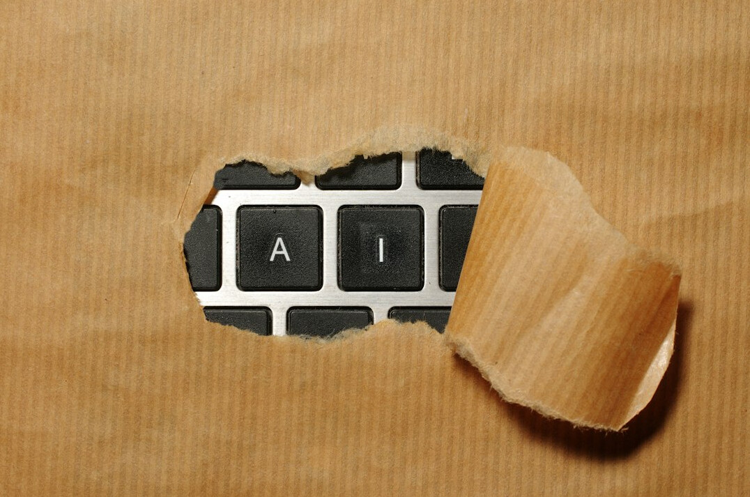 Hands typing on a laptop keyboard building a website