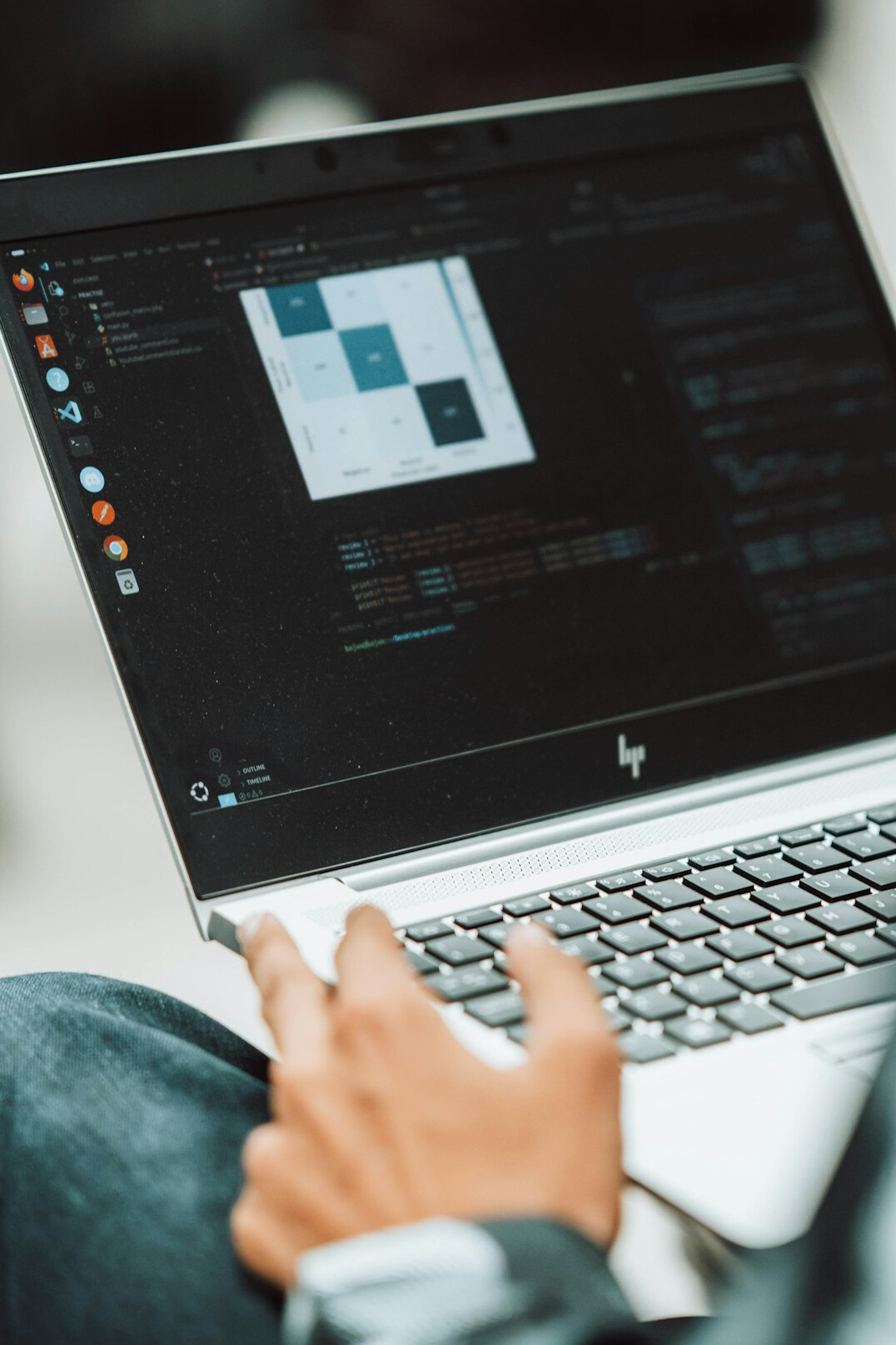 person coding on laptop
