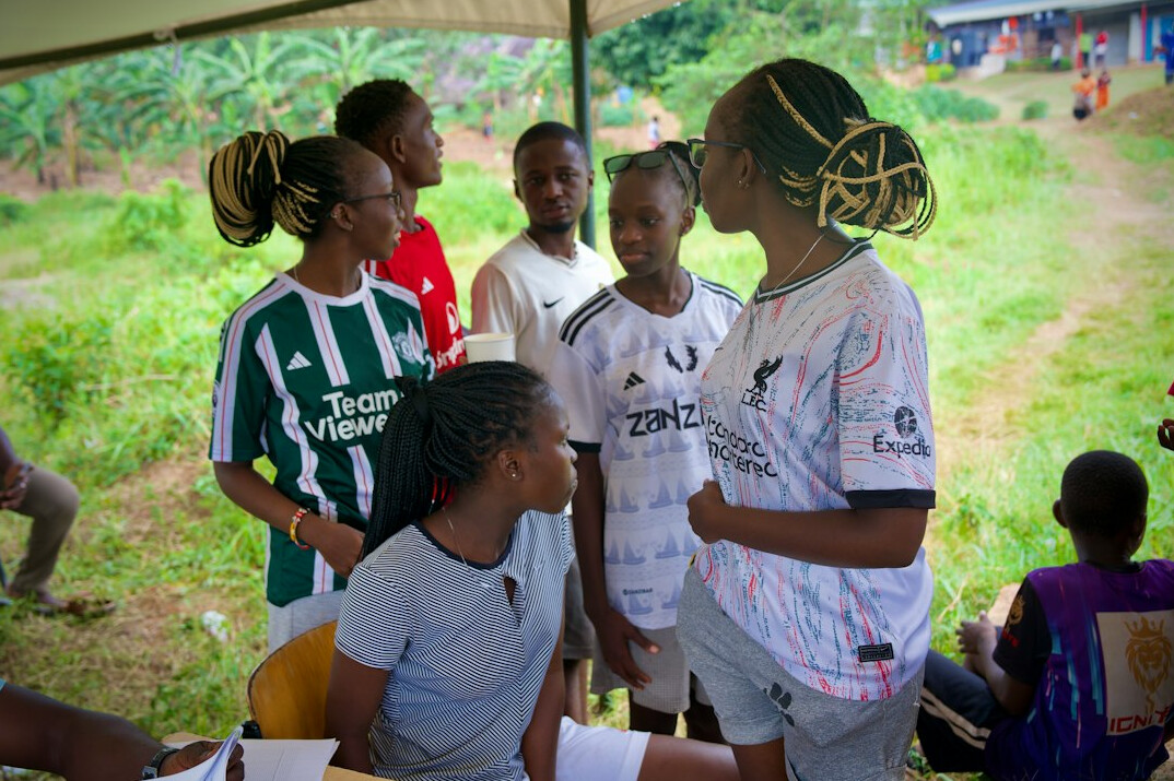 Two colleagues of Southern European ethnicity discussing a mobile app prototype on a laptop