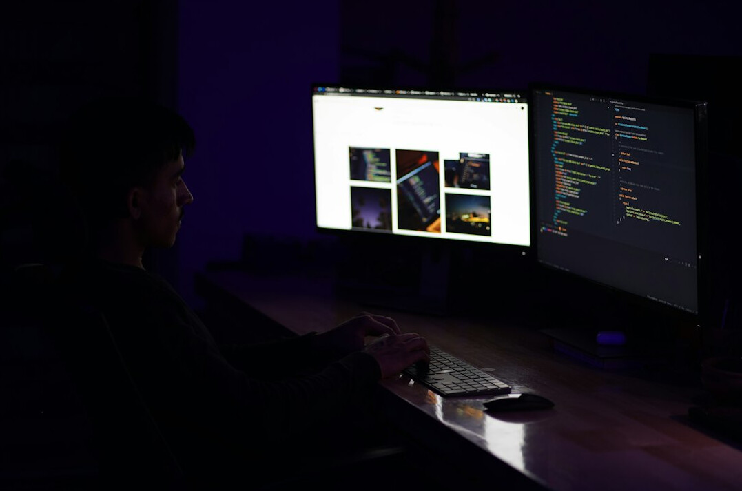 person coding at desk